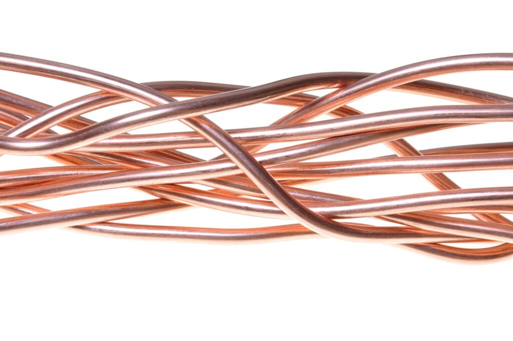 Curved, intertwined copper wires displayed against a white background, showcasing texture and form for industrial or artistic applications.
