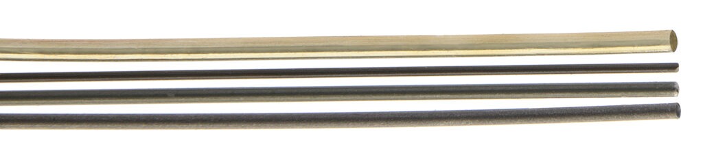 Four metal rods of varying lengths and colors, arranged horizontally. The rods showcase different finishes and material types, relevant for materials selection.