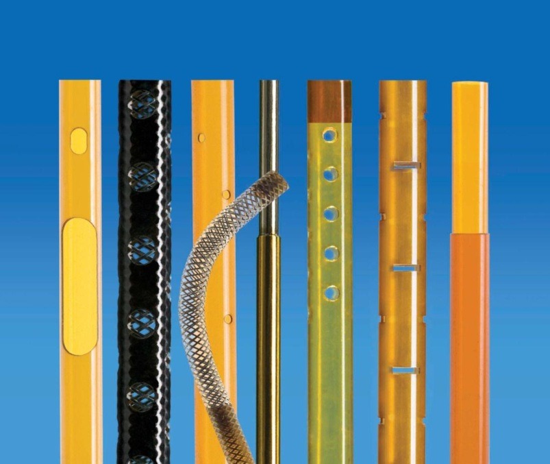Various types of yellow and black tubing are arranged vertically against a blue background, showcasing materials used for piping or insulation.