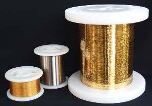 Spools of copper wire in varying sizes, featuring gold and silver metallic finishes, exemplifying materials used in electronics and crafting.