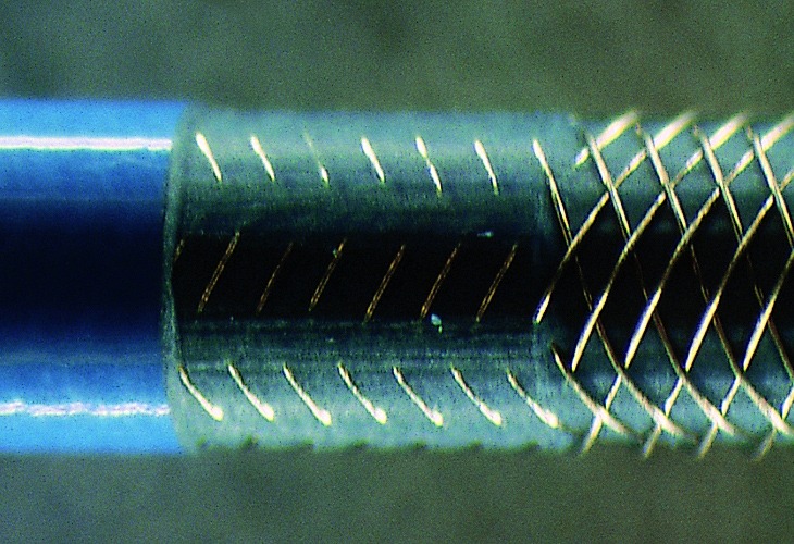 Close-up of a mechanical coupling, showing detailed threads and grooves. This image highlights precision engineering, essential for machinery assembly.