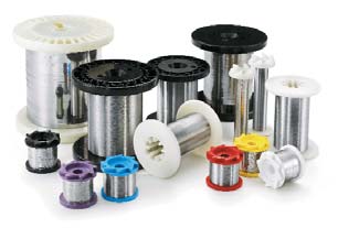 Collection of various spools filled with metallic wire in different colors and sizes, showcasing supplies for electrical and crafting projects.