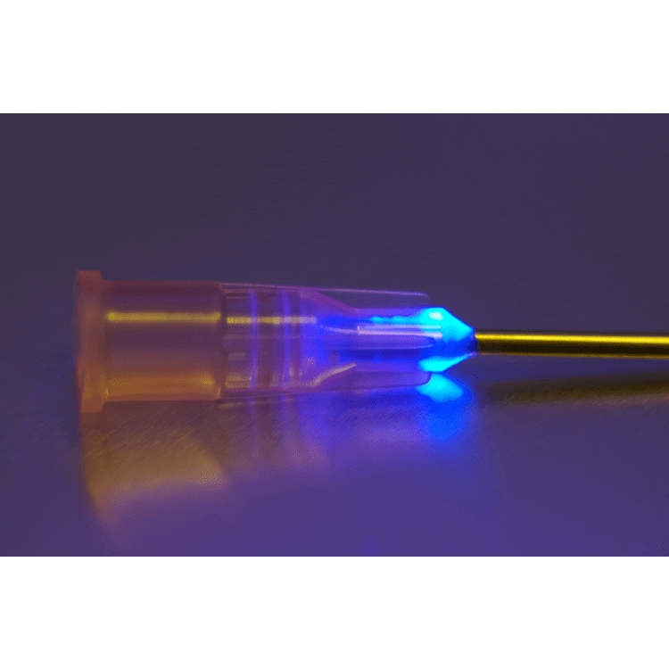 A glowing blue LED tip on a transparent syringe is shown against a dark background, highlighting its use in medical or laboratory settings.