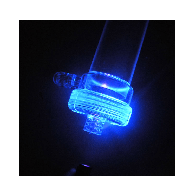 A glowing glass tube with a bright, orange plasma discharge visible at the top, illustrating a gas discharge experiment.